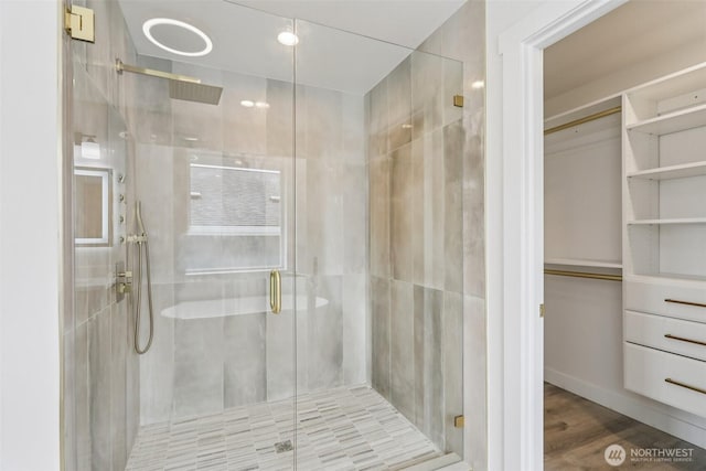 3102 44th Ave NE, Tacoma, WA 98422 - full bathroom featuring a stall shower, a spacious closet, and wood finished floors