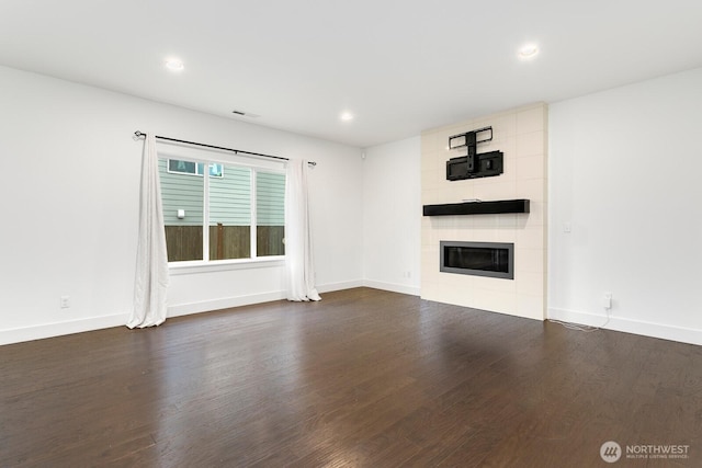 4214 223rd Pl SE, Bothell, WA 98021 - unfurnished living room with a tiled fireplace, dark wood-style floors, and recessed lighting