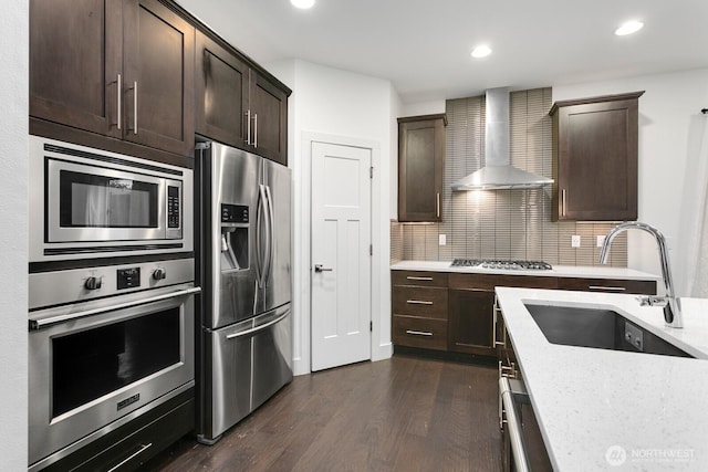 4214 223rd Pl SE, Bothell, WA 98021 - kitchen featuring stainless steel appliances, wall chimney range hood, dark wood-style flooring, dark brown cabinetry, and recessed lighting
