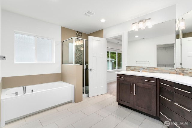 4214 223rd Pl SE, Bothell, WA 98021 - bathroom featuring a shower stall, a garden tub, vanity, tasteful backsplash, and recessed lighting