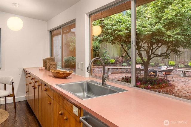 4148 Boulevard Pl, Mercer Island, WA 98040 - kitchen featuring dark wood-style floors, light countertops, healthy amount of natural light, and decorative light fixtures