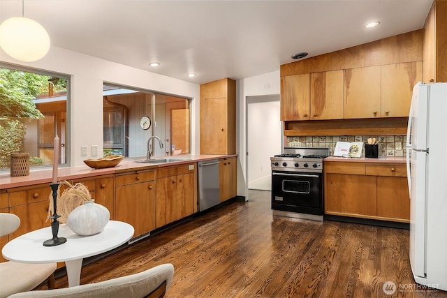 4148 Boulevard Pl, Mercer Island, WA 98040 - kitchen featuring stainless steel appliances, dark wood finished floors, light countertops, brown cabinetry, and recessed lighting