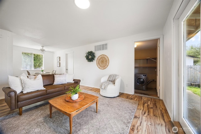 6819 Braker Way, Lynden, WA 98264 - living area featuring washer / clothes dryer, wood finished floors, and ceiling fan