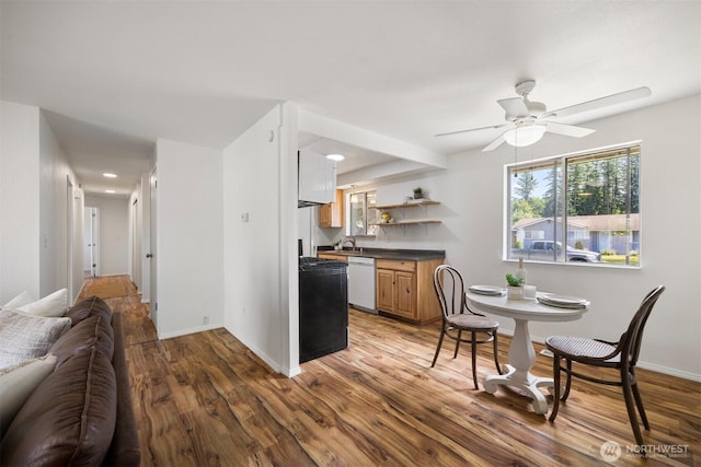 6819 Braker Way, Lynden, WA 98264 - kitchen featuring white dishwasher, dark countertops, wood finished floors, open floor plan, and ceiling fan