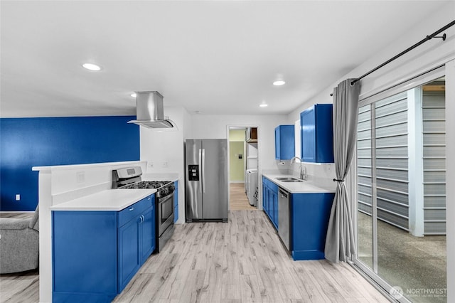 900 Dundee Rd NW, Olympia, WA 98502 - kitchen featuring appliances with stainless steel finishes, island range hood, blue cabinets, light wood-type flooring, and recessed lighting