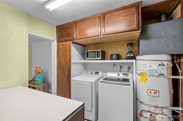900 Dundee Rd NW, Olympia, WA 98502 - washroom with strapped water heater, cabinet space, and separate washer and dryer
