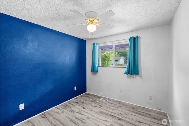 900 Dundee Rd NW, Olympia, WA 98502 - spare room with a textured ceiling, ceiling fan, and wood finished floors