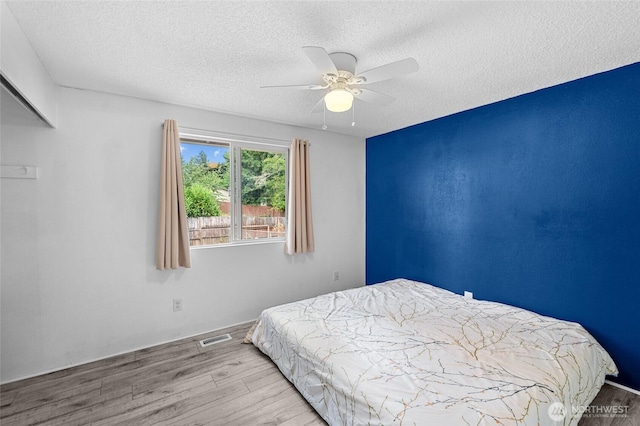 900 Dundee Rd NW, Olympia, WA 98502 - bedroom with a textured ceiling, wood finished floors, and a ceiling fan