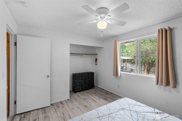 900 Dundee Rd NW, Olympia, WA 98502 - bedroom with a textured ceiling, wood finished floors, a closet, and ceiling fan