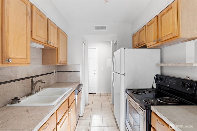 14510 124th Ave NE Unit H79, Kirkland, WA 98034 - kitchen with stainless steel electric range oven, light countertops, backsplash, and light tile patterned flooring
