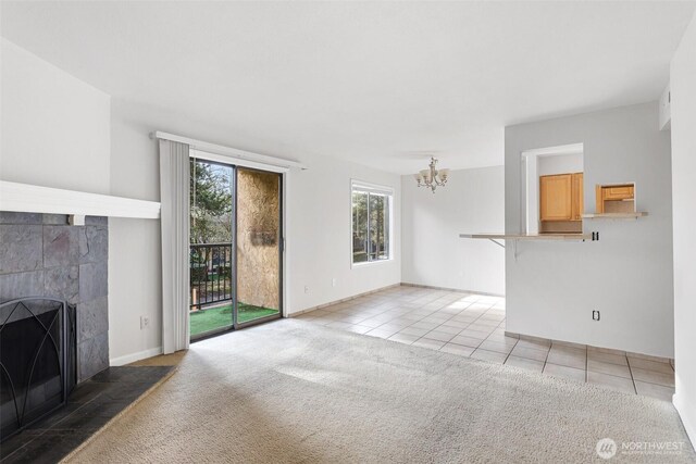 14510 124th Ave NE Unit H79, Kirkland, WA 98034 - unfurnished living room featuring a chandelier, light tile patterned flooring, a tile fireplace, and light carpet