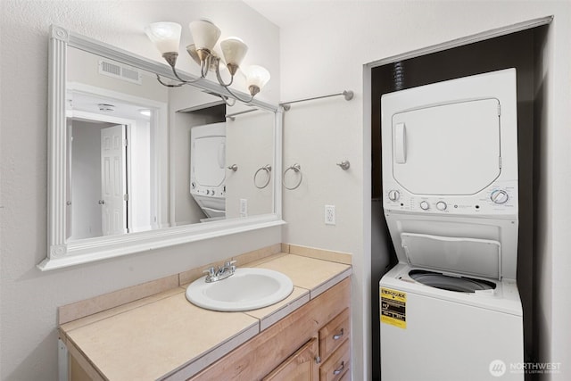 14510 124th Ave NE Unit H79, Kirkland, WA 98034 - bathroom with stacked washer / dryer, vanity, and a chandelier