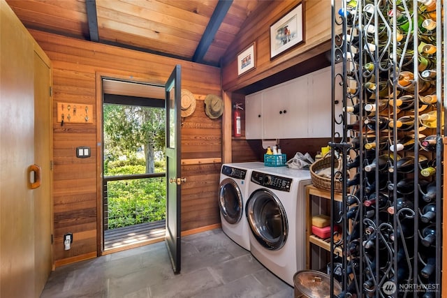 512 Broken Point Rd, Shaw Island, WA 98286 - laundry area with washing machine and clothes dryer, wood ceiling, wooden walls, and cabinet space