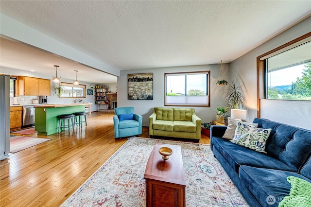 1121 W 12th St, Port Angeles, WA 98363 - living room with light wood finished floors and a textured ceiling