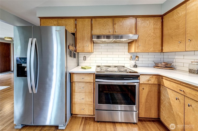 1121 W 12th St, Port Angeles, WA 98363 - kitchen featuring stainless steel appliances, range hood, light wood-style floors, and light countertops