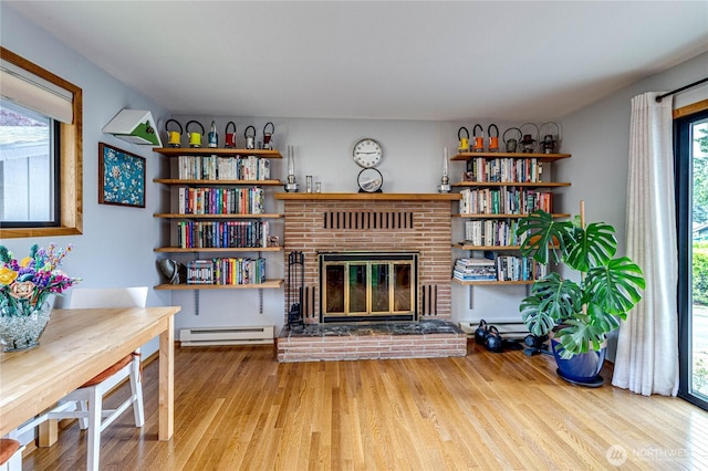 1121 W 12th St, Port Angeles, WA 98363 - living area with wood finished floors, baseboard heating, and a fireplace