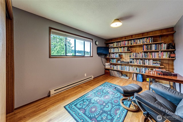 1121 W 12th St, Port Angeles, WA 98363 - sitting room with a baseboard heating unit, wood finished floors, and a textured ceiling