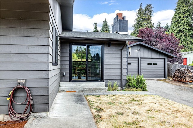 1121 W 12th St, Port Angeles, WA 98363 - view of exterior entry with a chimney and driveway