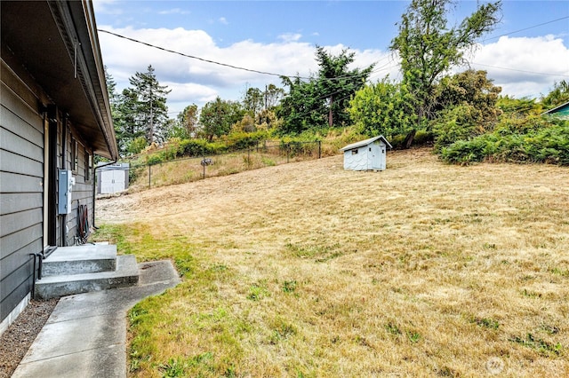 1121 W 12th St, Port Angeles, WA 98363 - view of grassy yard featuring a storage unit