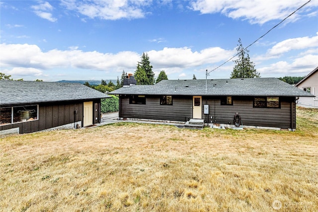 1121 W 12th St, Port Angeles, WA 98363 - back of property with a yard, a chimney, and entry steps