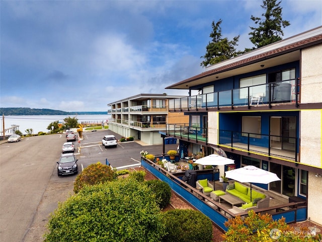 516 S 222nd St Unit 4, Des Moines, WA 98198 - view of building exterior featuring uncovered parking and a water view