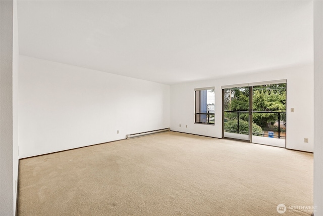 516 S 222nd St Unit 4, Des Moines, WA 98198 - empty room featuring a baseboard heating unit and light colored carpet