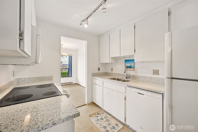 516 S 222nd St Unit 4, Des Moines, WA 98198 - kitchen with white appliances, white cabinetry, light tile patterned flooring, a chandelier, and rail lighting