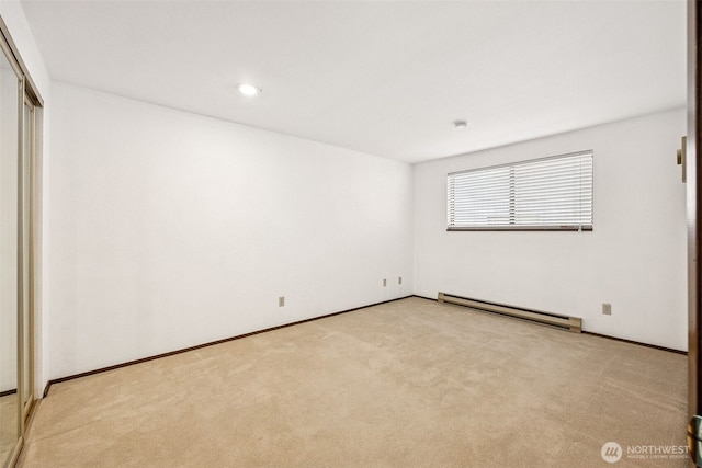 516 S 222nd St Unit 4, Des Moines, WA 98198 - unfurnished bedroom with a baseboard radiator, light carpet, and a closet
