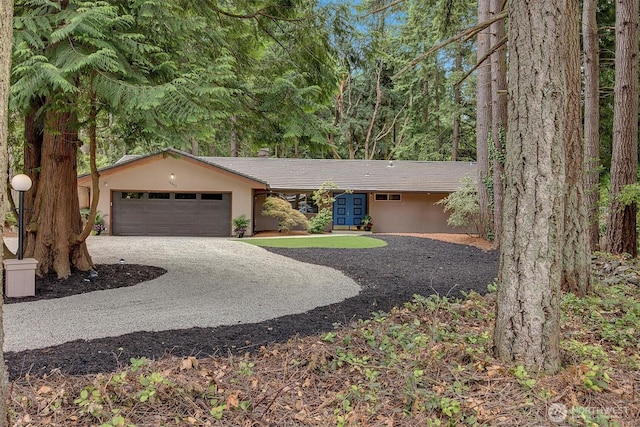 15025 SE 22nd St, Bellevue, WA 98007 - ranch-style house featuring gravel driveway, an attached garage, and stucco siding