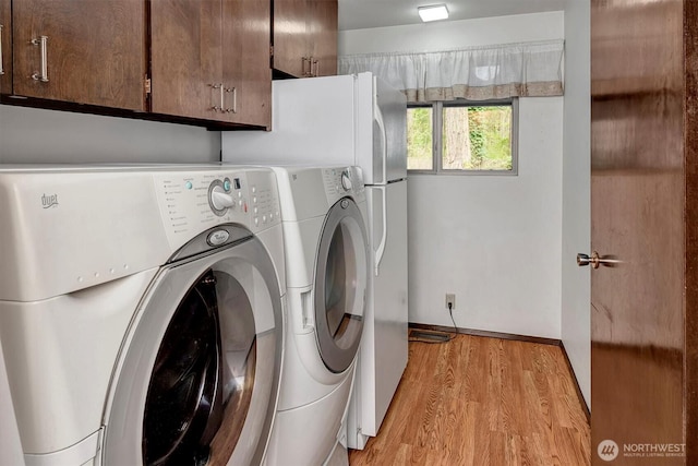 15025 SE 22nd St, Bellevue, WA 98007 - laundry area featuring light wood-style flooring and washing machine and dryer