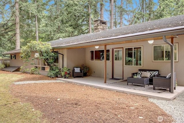 15025 SE 22nd St, Bellevue, WA 98007 - back of property with outdoor lounge area, a chimney, and a patio