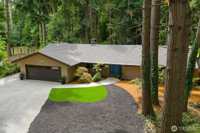 15025 SE 22nd St, Bellevue, WA 98007 - view of front of house with a garage, a tiled roof, stucco siding, driveway, and a chimney