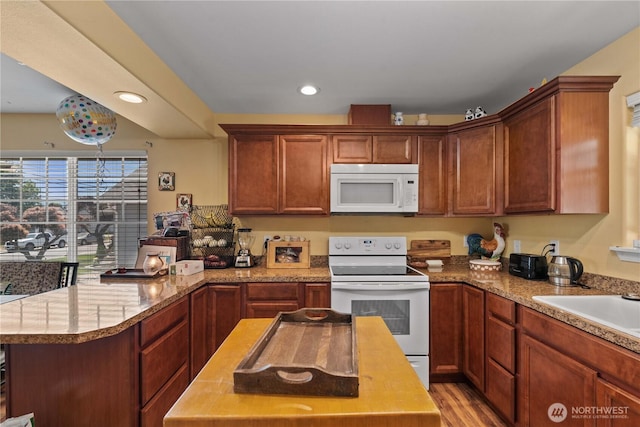 658 Okanogan Ave, Wenatchee, WA 98801 - kitchen with white appliances, a peninsula, recessed lighting, light wood finished floors, and light stone countertops