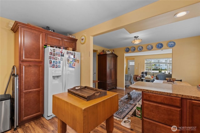 658 Okanogan Ave, Wenatchee, WA 98801 - kitchen with white fridge with ice dispenser, light wood-type flooring, light countertops, open floor plan, and brown cabinetry