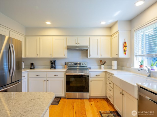501 Summer Breeze Ln, Sequim, WA 98382 - kitchen with stainless steel appliances, under cabinet range hood, light countertops, white cabinets, and recessed lighting