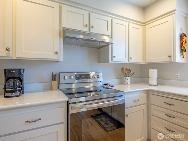 501 Summer Breeze Ln, Sequim, WA 98382 - kitchen featuring stainless steel electric range, under cabinet range hood, white cabinetry, and light stone countertops