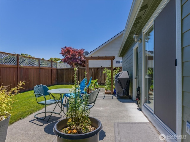 501 Summer Breeze Ln, Sequim, WA 98382 - fenced backyard featuring a grill, a patio, and outdoor dining area
