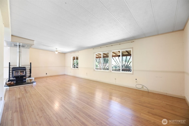 15932 427th Ave SE, Gold Bar, WA 98251 - unfurnished living room featuring a wood stove and wood finished floors