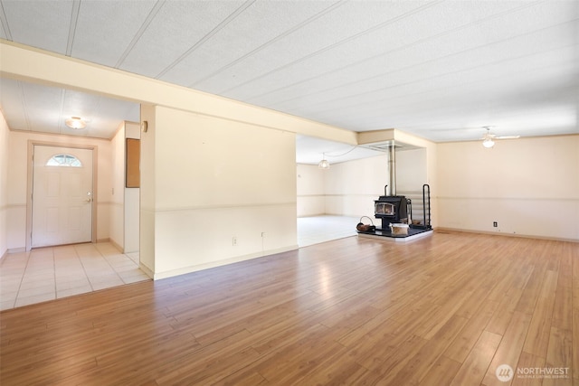 15932 427th Ave SE, Gold Bar, WA 98251 - unfurnished living room with a wood stove, light wood-type flooring, and ceiling fan