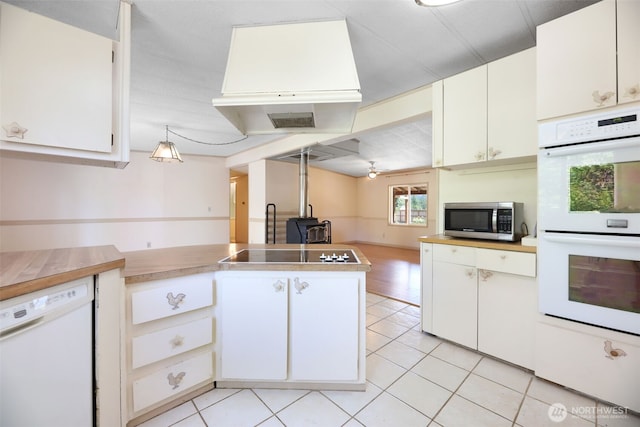 15932 427th Ave SE, Gold Bar, WA 98251 - kitchen with white appliances, light tile patterned floors, a peninsula, and light countertops