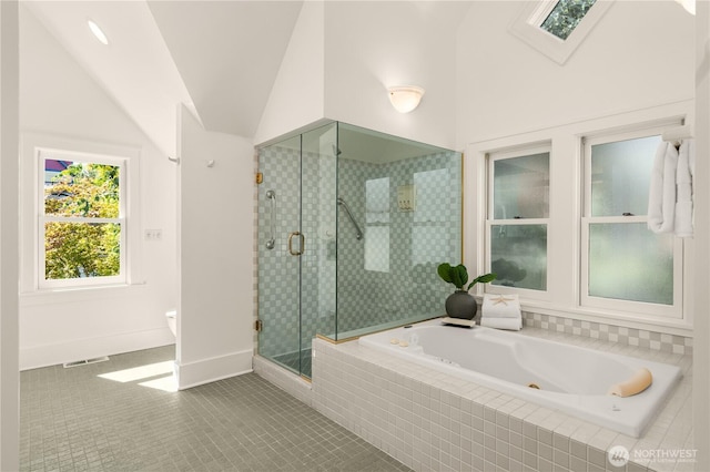 1515 2nd Ave W, Seattle, WA 98119 - bathroom featuring a tub with jets, lofted ceiling, a stall shower, and tile patterned flooring