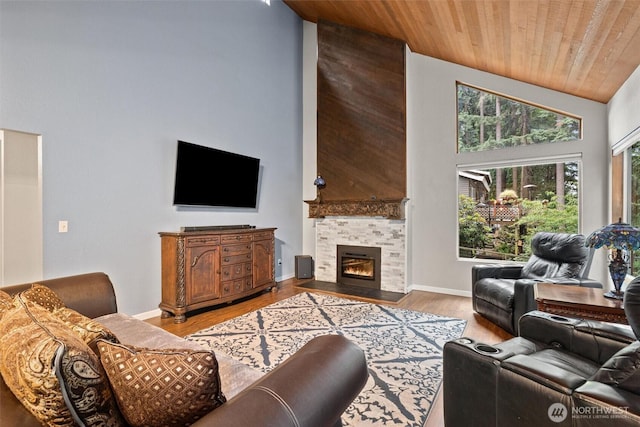 19833 95th Ave NE, Bothell, WA 98011 - living room with wooden ceiling, high vaulted ceiling, light wood-style floors, and a tiled fireplace
