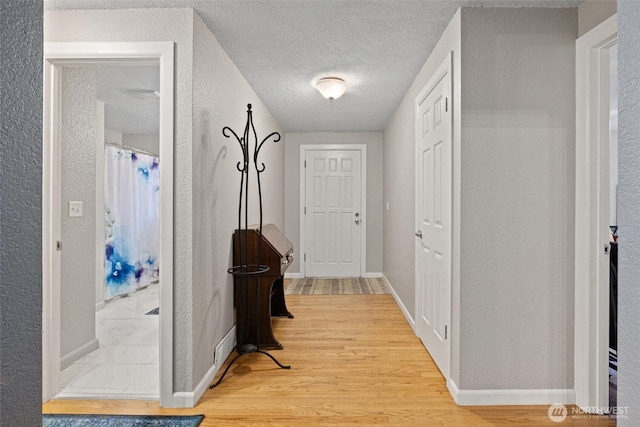 19833 95th Ave NE, Bothell, WA 98011 - corridor featuring wood finished floors, a textured wall, and a textured ceiling