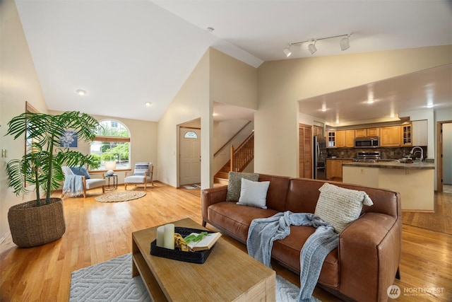 3120 Tanglewood Ln, Bellingham, WA 98226 - living room featuring light wood-type flooring, stairway, and high vaulted ceiling