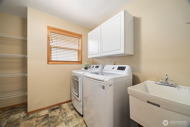 3120 Tanglewood Ln, Bellingham, WA 98226 - washroom featuring independent washer and dryer, cabinet space, and light stone finish flooring