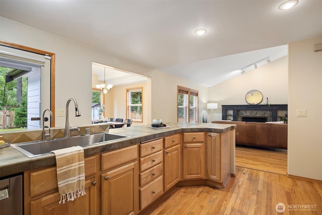 3120 Tanglewood Ln, Bellingham, WA 98226 - kitchen with a fireplace, light wood-type flooring, lofted ceiling, tile counters, and a chandelier