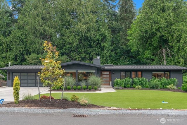 23406 Humber Ln, Edmonds, WA 98020 - view of front facade featuring a standing seam roof, a front lawn, a chimney, and driveway