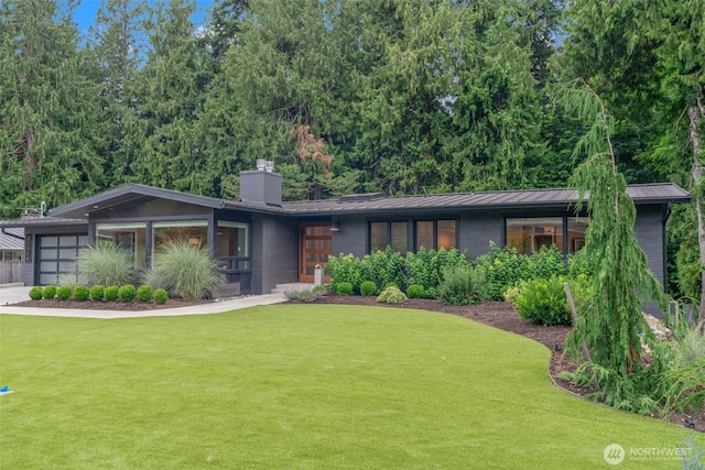 23406 Humber Ln, Edmonds, WA 98020 - mid-century home featuring a front lawn, a standing seam roof, a chimney, and an attached garage