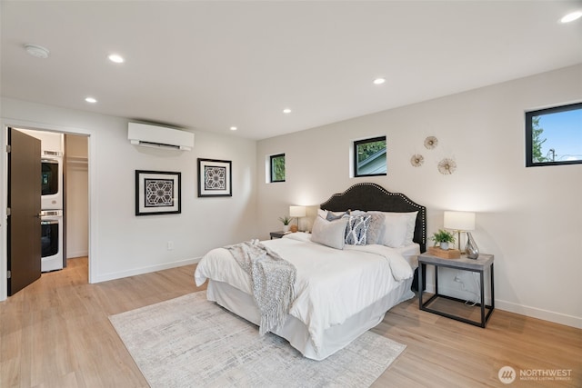 23406 Humber Ln, Edmonds, WA 98020 - bedroom with a wall unit AC, light wood-type flooring, recessed lighting, and a spacious closet