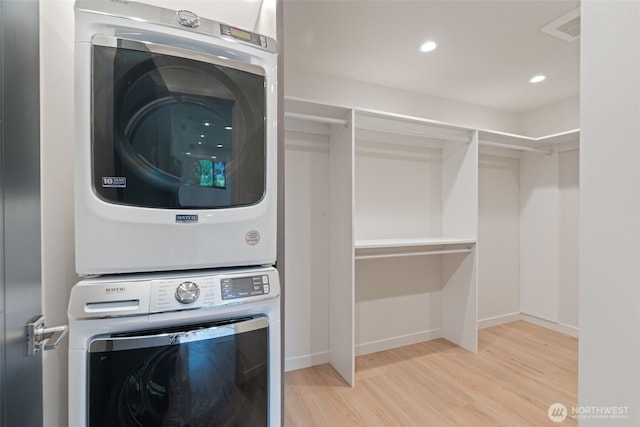 23406 Humber Ln, Edmonds, WA 98020 - laundry room featuring stacked washer / dryer, wood finished floors, and recessed lighting